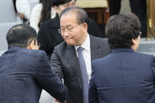 윤재옥(가운데) 국민의힘 원내대표가 26일 국회에서 열린 당 원내대책회의에 참석하며 의원들과 인사를 나누고 있다.<연합뉴스>